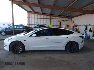 2021 Tesla Model 3 Performance with VIN 5YJ3E1EC4MF097993, listed as a IAAI auction lot 41366615 with 30,735 mi miles and . Bid and sale history available at DreamBid. Image 14.