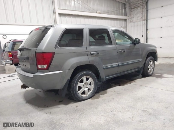 2008 Jeep Grand Cherokee Laredo with VIN 1J8GR48K58C119411, listed as a IAAI auction lot 41637142 with 212,729 mi miles. Bid and sale history available at carsss.com. Image 4.