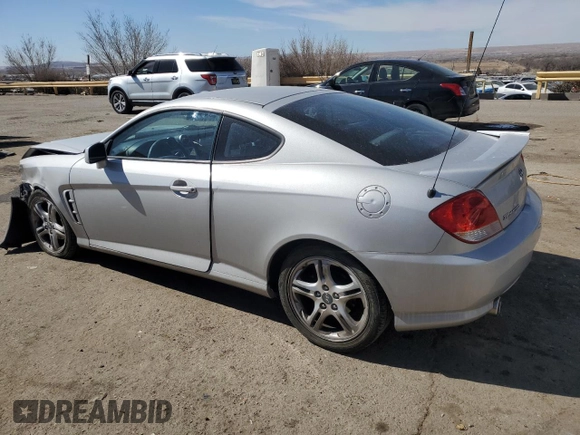 2006 Hyundai Tiburon GT z VIN KMHHN65F76U190851, wystawiony jako Copart lot #45935795 z przebiegiem 102 335 mil mil oraz Szkoda całkowita • Salvage title. Historia ofert i sprzedaży dostępna na DreamBid. Obrazek 2.