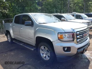 2015 GMC Canyon 2WD SLE z VIN 1GTG5BEA1F1224541, wystawiony jako IAAI lot #42423275 z przebiegiem 128 708 mil mil oraz . Historia ofert i sprzedaży dostępna na DreamBid. Obrazek 1.