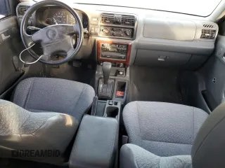 1999 Isuzu Rodeo S with VIN 4S2CK58W2X4361475, listed as a Copart auction lot 63873864 with 232,406 mi miles and Salvage Title. Bid and sale history available at DreamBid. Image 8.