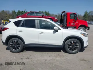 2016 Mazda CX-5 Grand Touring with VIN JM3KE4DY0G0632693, listed as a IAAI auction lot 42123142 with 106,592 mi miles. Bid and sale history available at carsss.com. Image 13.