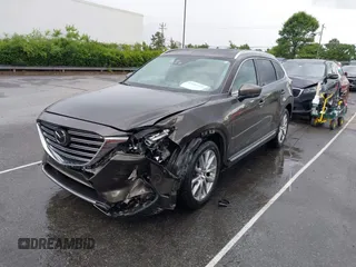 2016 Mazda CX-9 Grand Touring z VIN JM3TCADY6G0126391, wystawiony jako IAAI lot #42242541 z przebiegiem 45 147 mil mil oraz . Historia ofert i sprzedaży dostępna na DreamBid. Obrazek 2.