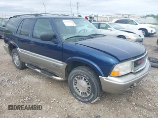 1999 GMC Jimmy SLE z VIN 1GKDT13W5X2548528, wystawiony jako IAAI lot #42279721 z przebiegiem Nie podano mil oraz . Historia ofert i sprzedaży dostępna na DreamBid. Obrazek 1.