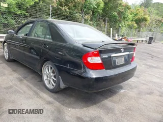 2003 Toyota Camry LE with VIN JTDBF32K430146557, listed as a IAAI auction lot 42102454 with 179,653 mi miles. Bid and sale history available at carsss.com. Image 3.