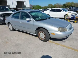 1999 Mercury Sable z VIN 1MEFM53U7XG665133, wystawiony jako IAAI lot #41787750 z przebiegiem 97 898 mil mil oraz . Historia ofert i sprzedaży dostępna na DreamBid. Obrazek 1.
