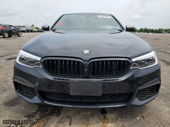 2018 BMW 5 Series M550i xDrive with VIN WBAJB9C51JB286700, listed as a Copart auction lot 64681004 with 76,304 mi miles and Salvage Title. Bid and sale history available at carsss.com. Image 5.