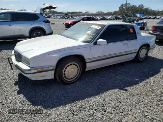 1990 Cadillac Eldorado z VIN 1G6EL1334LU616468, wystawiony jako Copart lot #76398934 z przebiegiem Nie podano mil oraz Szkody całkowita. Historia ofert i sprzedaży dostępna na DreamBid. Obrazek 1.