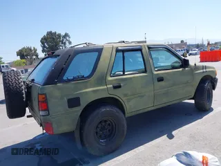 1995 Isuzu Rodeo z VIN 4S2CK58E5S4379419, wystawiony jako IAAI lot #42094055 z przebiegiem 196 175 mil mil oraz . Historia ofert i sprzedaży dostępna na DreamBid. Obrazek 4.
