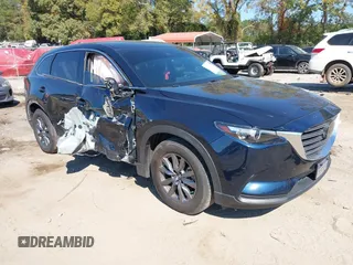 2022 Mazda CX-9 Touring z VIN JM3TCBCY3N0606814, wystawiony jako IAAI lot #40687356 z przebiegiem 57 241 mil mil oraz . Historia ofert i sprzedaży dostępna na DreamBid. Obrazek 1.