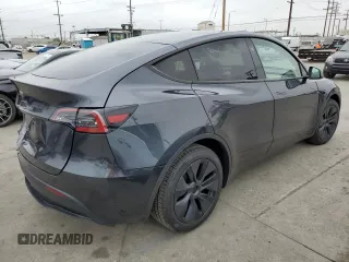 2025 Tesla Model Y Long Range with VIN 7SAYGDED4SF242721, listed as a Copart auction lot 56159955 with 7,131 mi miles and Salvage Title. Bid and sale history available at DreamBid. Image 3.