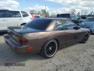 1991 Nissan 240SX z VIN JN1MS34PXMW001053, wystawiony jako Copart lot #79007744 z przebiegiem 172 425 mil mil oraz Nie do naprawy. Historia ofert i sprzedaży dostępna na DreamBid. Obrazek 3.