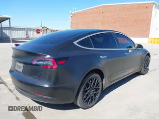 2020 Tesla Model 3 Standard Range Plus with VIN 5YJ3E1EA0LF597761, listed as a IAAI auction lot 41773918 with 89,957 mi miles. Bid and sale history available at carsss.com. Image 4.