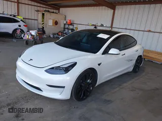 2021 Tesla Model 3 Performance with VIN 5YJ3E1EC4MF097993, listed as a IAAI auction lot 41366615 with 30,735 mi miles and . Bid and sale history available at DreamBid. Image 2.
