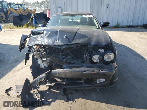 2004 Jaguar XJ with VIN SAJEA71C74SG02851, listed as a Copart auction lot 69056994 with 0 mi miles and Salvage Title. Bid and sale history available at carsss.com. Image 4.
