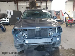 2003 Jeep Grand Cherokee Laredo with VIN 1J4GW48S33C539977, listed as a IAAI auction lot 42027703 with 100,534 mi miles. Bid and sale history available at carsss.com. Image 13.