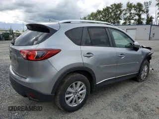 2014 Mazda CX-5 Touring z VIN JM3KE4CY0E0407169, wystawiony jako Copart lot #57877215 z przebiegiem 168 277 mil mil oraz Szkoda całkowita • Salvage title. Historia ofert i sprzedaży dostępna na DreamBid. Obrazek 3.