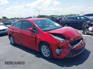 2021 Toyota Prius L Eco z VIN JTDKAMFU4M3145215, wystawiony jako IAAI lot #42281566 z przebiegiem 74 220 mil mil oraz . Historia ofert i sprzedaży dostępna na DreamBid. Obrazek 1.