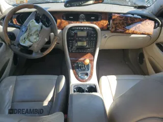 2004 Jaguar XJ with VIN SAJEA71C74SG02851, listed as a Copart auction lot 69056994 with 0 mi miles and Salvage Title. Bid and sale history available at carsss.com. Image 7.