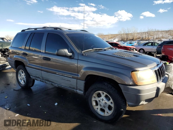 1999 Jeep Grand Cherokee Laredo with VIN 1J4GW58N9XC633464, listed as a Copart auction lot 84682454 with 212,738 mi miles and Salvage title. Bid and sale history available at DreamBid. Image 4.