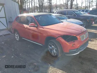 2015 BMW X1 xDrive28i with VIN WBAVL1C58FVY24900, listed as a IAAI auction lot 41772097 with 128,001 mi miles. Bid and sale history available at carsss.com. Image 1.