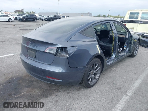 2023 Tesla Model 3 with VIN 5YJ3E1EA4PF410060, listed as a IAAI auction lot 42067624 with 59,934 mi miles and . Bid and sale history available at DreamBid. Image 4.