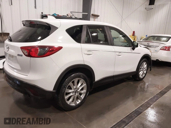 2015 Mazda CX-5 Grand Touring with VIN JM3KE4DY4F0495627, listed as a IAAI auction lot 41887773 with 130,421 mi miles. Bid and sale history available at carsss.com. Image 4.