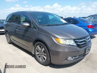 2014 Honda Odyssey Touring with VIN 5FNRL5H99EB075979, listed as a IAAI auction lot 42520154 with 99,314 mi miles and . Bid and sale history available at DreamBid. Image 1.