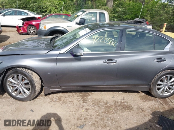 2015 Infiniti Q50 Premium z VIN JN1BV7AR1FM398047, wystawiony jako IAAI lot #42203862 z przebiegiem 104 002 mil mil oraz . Historia ofert i sprzedaży dostępna na DreamBid. Obrazek 14.