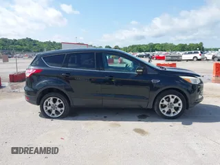2013 Ford Escape SEL with VIN 1FMCU9HX1DUB97939, listed as a IAAI auction lot 42293561 with 196,951 mi miles and . Bid and sale history available at DreamBid. Image 14.
