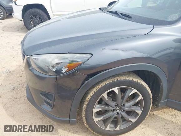 2016 Mazda CX-5 Grand Touring z VIN JM3KE2DY5G0801238, wystawiony jako IAAI lot #42264694 z przebiegiem 136 993 mil mil oraz . Historia ofert i sprzedaży dostępna na DreamBid. Obrazek 6.