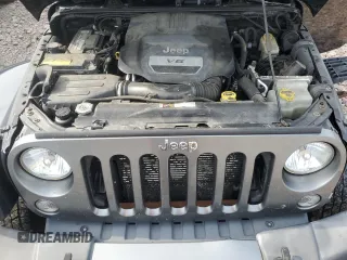 2015 Jeep Wrangler Unlimited Freedom with VIN 1C4BJWDG4FL568601, listed as a Copart auction lot 64041415 with 128,874 mi miles and Salvage title. Bid and sale history available at DreamBid. Image 12.
