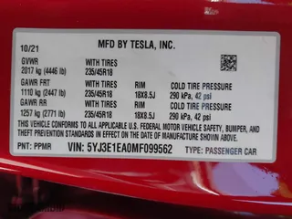2021 Tesla Model 3 Standard Range Plus with VIN 5YJ3E1EA0MF099562, listed as a IAAI auction lot 41771323 with 26,087 mi miles. Bid and sale history available at carsss.com. Image 9.