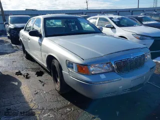 1999 Mercury Grand Marquis GS with VIN 2MEFM74W1XX669314, listed as a IAAI auction lot 41288768 with 215,636 mi miles. Bid and sale history available at carsss.com. Image 1.