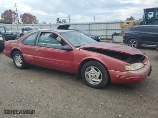 1996 Ford Thunderbird LX with VIN 1FALP62W7TH135632, listed as a Copart auction lot 77134024 with 128,931 mi miles and Salvage Title. Bid and sale history available at carsss.com. Image 4.