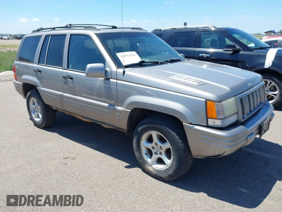 1998 Jeep Grand Cherokee Limited z VIN 1J4GZ88Z4WC328450, wystawiony jako IAAI lot #42652126 z przebiegiem 166 576 mil mil oraz . Historia ofert i sprzedaży dostępna na DreamBid. Obrazek 1.