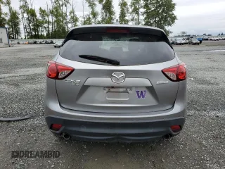 2014 Mazda CX-5 Touring z VIN JM3KE4CYXE0426408, wystawiony jako Copart lot #57355115 z przebiegiem Nie podano mil oraz Szkody całkowita. Historia ofert i sprzedaży dostępna na DreamBid. Obrazek 6.