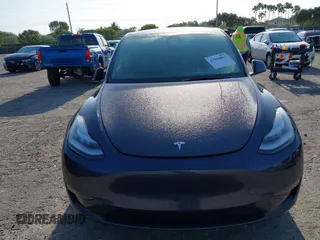 2023 Tesla Model Y Long Range z VIN 7SAYGDEE5PA099226, wystawiony jako IAAI lot #42004061 z przebiegiem 10 607 mil mil oraz . Historia ofert i sprzedaży dostępna na DreamBid. Obrazek 6.