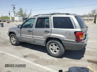 1999 Jeep Grand Cherokee Laredo with VIN 1J4GW58S1XC775877, listed as a Copart auction lot 55639795 with 197,611 mi miles and Salvage title. Bid and sale history available at DreamBid. Image 2.