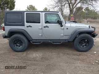 2013 Jeep Wrangler Unlimited Rubicon z VIN 1C4BJWFG7DL667083, wystawiony jako IAAI lot #42016912 z przebiegiem 148 933 mil mil oraz . Historia ofert i sprzedaży dostępna na DreamBid. Obrazek 13.