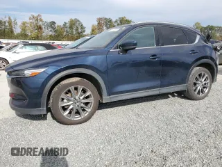 2021 Mazda CX-5 Signature with VIN JM3KFBEY3M0439658, listed as a Copart auction lot 74534464 with 50,816 mi miles and Salvage Title. Bid and sale history available at carsss.com. Image 1.