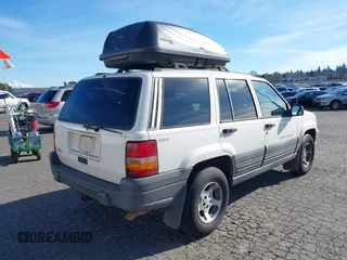 1996 Jeep Grand Cherokee Laredo z VIN 1J4GZ58Y5TC186403, wystawiony jako IAAI lot #41562270 z przebiegiem 205 797 mil mil oraz . Historia ofert i sprzedaży dostępna na DreamBid. Obrazek 4.