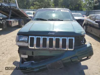 1998 Jeep Grand Cherokee with VIN 1J4FX48S8WC281615, listed as a Copart auction lot 77305594 with 128,393 mi miles and Salvage title. Bid and sale history available at DreamBid. Image 5.