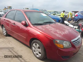 2009 Kia Spectra EX with VIN KNAFE221195606045, listed as a IAAI auction lot 42128548 with 124,577 mi miles. Bid and sale history available at carsss.com. Image 1.