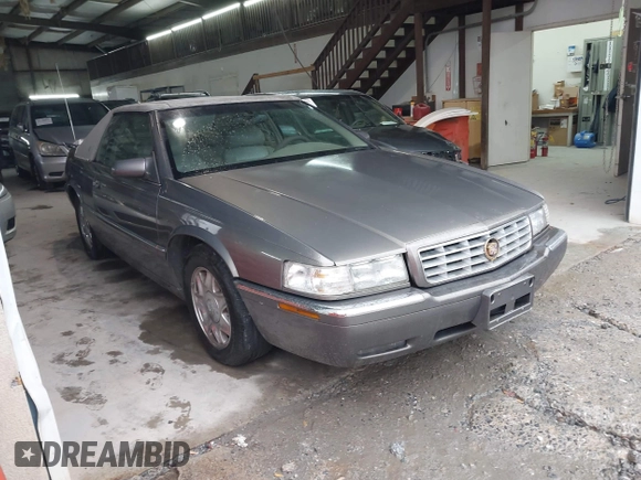 1999 Cadillac Eldorado ESC z VIN 1G6EL12Y8XU612393, wystawiony jako IAAI lot #41761839 z przebiegiem 104 994 mil mil oraz . Historia ofert i sprzedaży dostępna na DreamBid. Obrazek 1.