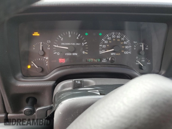 1999 Jeep Cherokee Sport with VIN 1J4FT68S1XL577603, listed as a Copart auction lot 54216115 with 180,128 mi miles and Salvage title. Bid and sale history available at DreamBid. Image 9.