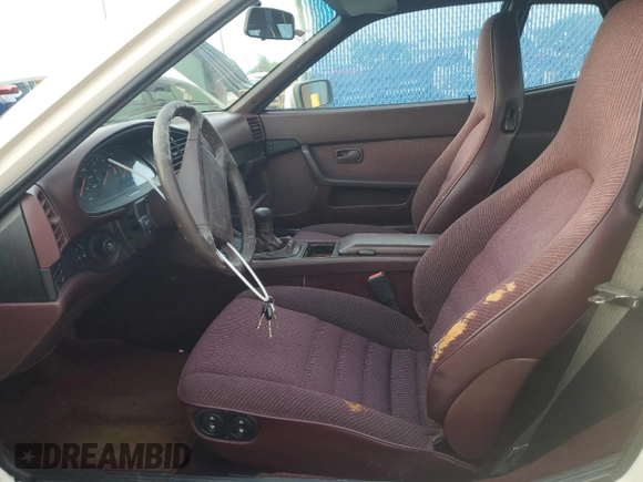1987 Porsche 944 z VIN WP0AB0948HN473051, wystawiony jako Copart lot #73666654 z przebiegiem 82 580 mil mil oraz Szkoda całkowita • Salvage title. Historia ofert i sprzedaży dostępna na DreamBid. Obrazek 7.