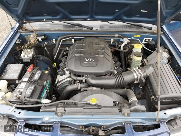 2002 Isuzu Rodeo S with VIN 4S2CK58W124301647, listed as a Copart auction lot 56973895 with 129,009 mi miles and Salvage title. Bid and sale history available at DreamBid. Image 12.