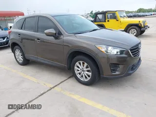 2016 Mazda CX-5 Sport z VIN JM3KE2BY8G0873831, wystawiony jako IAAI lot #42094180 z przebiegiem 137 051 mil mil oraz . Historia ofert i sprzedaży dostępna na DreamBid. Obrazek 1.