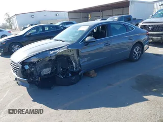 2022 Hyundai Sonata Hybrid Blue with VIN KMHL24JJ1NA041773, listed as a IAAI auction lot 41043553 with 23,696 mi miles. Bid and sale history available at carsss.com. Image 2.